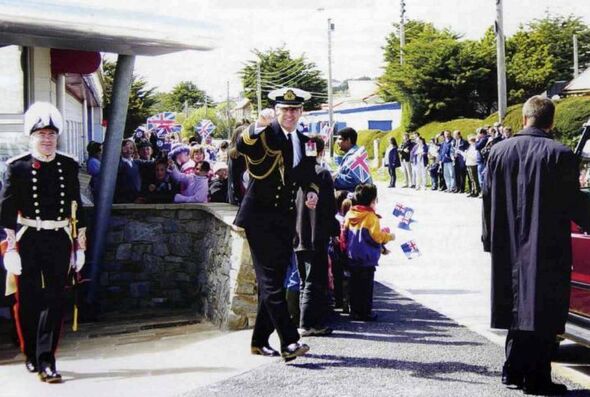 Man in naval uniform greeted by crowds Man in naval uniform greeted by crowds