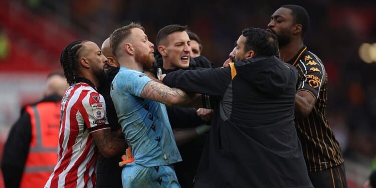Championship match ends in complete chaos with huge brawl as fans held back by security