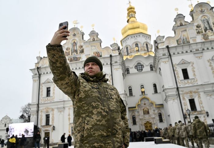 A Ukrainian serviceman takes a selfie before the Christmas service in the Assumption Cathedral of the Kyiv Pechersk Lavra on January 7, 2023, amid the Russian Invasion of Ukraine.