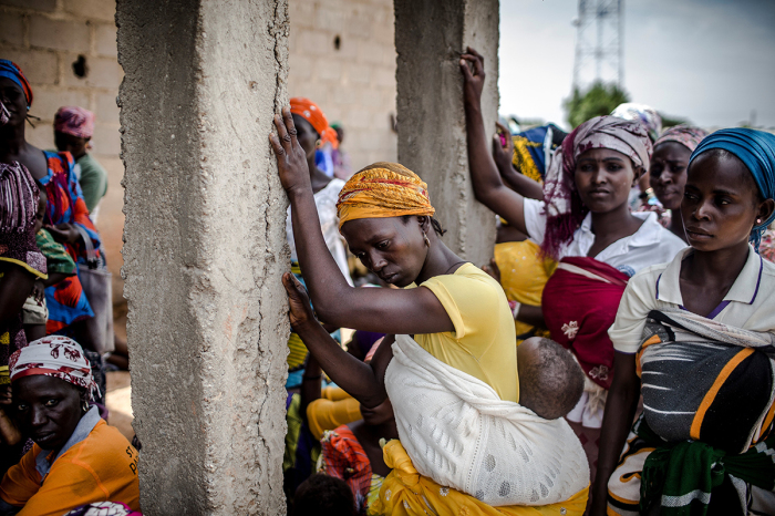A group of Christian Adara farmers gather at the entrance of a church after the Sunday's service at Ecwa Church, Kajuru, Kaduna State, Nigeria, on April 14, 2019.