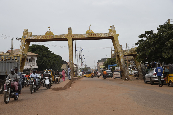 Motor bike taxis drive past Kofar Aliyu Jedo, a city gate in ancient Sokoto, northwest Nigeria on September 21, 2021.