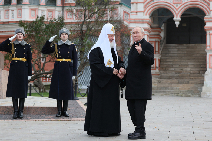 This pool photograph distributed by Russian state-owned agency Sputnik shows Russia's President Vladimir Putin and Russian Orthodox Patriarch Kirill (L) talking during a wreath-laying ceremony at the Monument to Minin and Pozharsky on Red Square on the National Unity Day in Moscow on November 4, 2023.