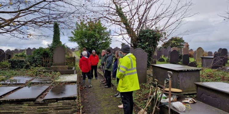 Refugees and asylum-seekers plant bluebells in Welsh churchyard to encourage friendship