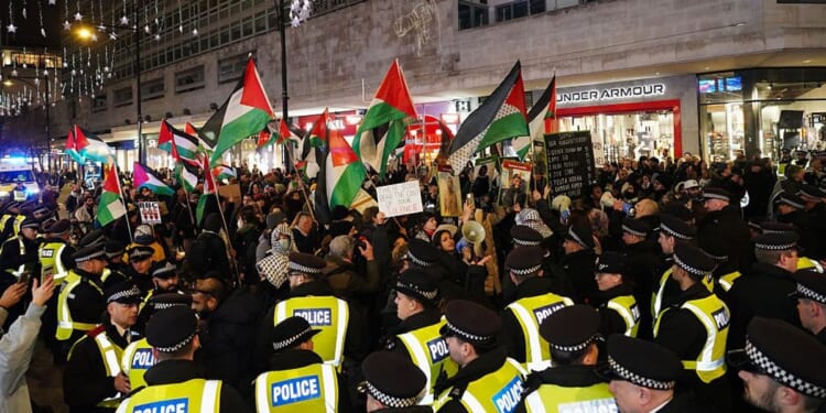 Pro-Palestine protesters arrested after calling for 'intifada' just hours after Met Police announced plans to detain anyone chanting antisemitic slogans