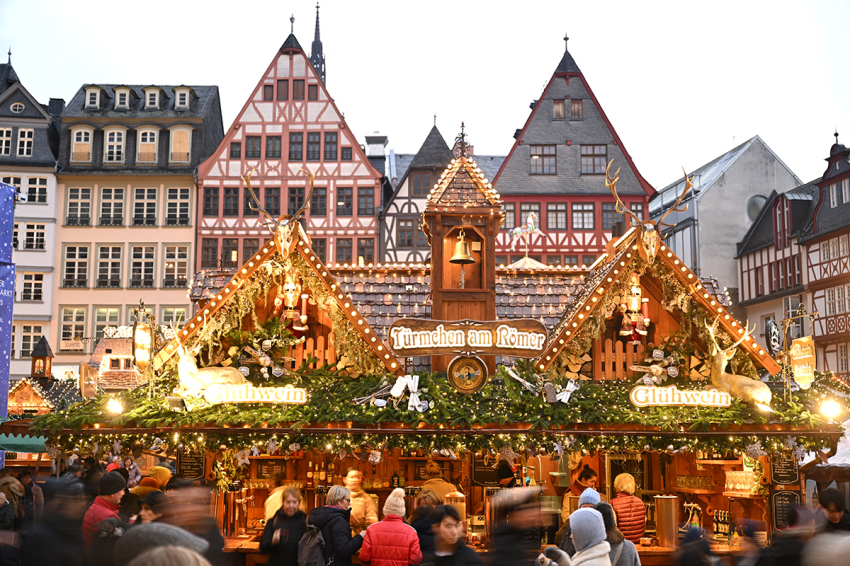 People walk around the Christmas market at the central Roemer square in Frankfurt am Main, Germany, on Nov. 24, 2025.