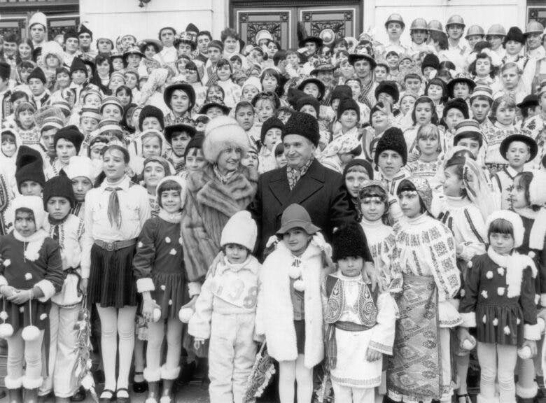 circa 1985: Romanian dictator Nicolae Ceausescu (1918 - 1989) and his wife Elena with a large group of children in national costume. (Photo by Keystone/Getty Images)