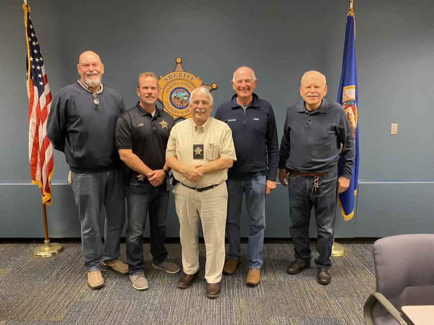 Pastor James “Jim” Bzoskie (center) pictured at the Dakota County Sheriff's Office. 