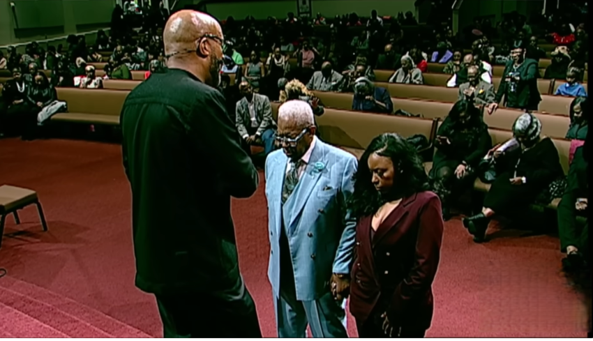 Rev. Frederick Douglass Haynes III prays over Rep. Jasmine Crockett, D-Texas, and her father, at Friendship-West Baptist Church in Dallas, Texas, on Sunday, December 7, 2025.