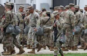 Members of the Texas National Guard assemble at the Army Reserve Training Center in Elwood, Illinois