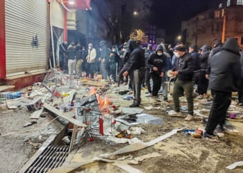 Protesters chant 'death to the dictator' as they set fire to state broadcasting building