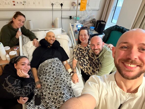 Dean surrounded by his family in hospital