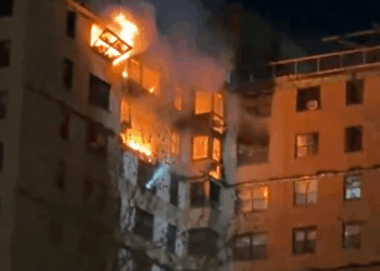Emergency crews rush to huge blaze engulfing upper floors of high-rise