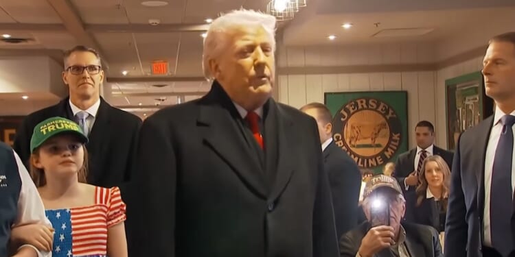 Trump prays with supporter during campaign stop in Iowa