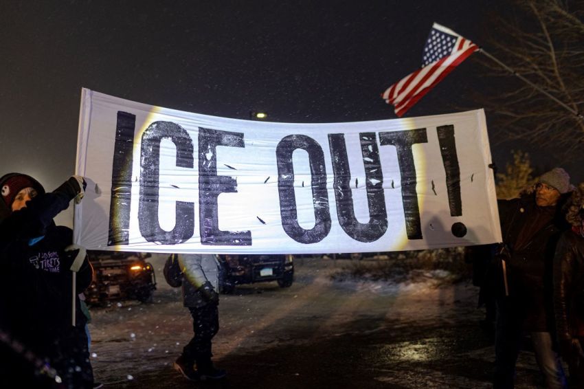 Protesters with a large anti-ICE sign, stand outside of the Henry Bishop Whipple Federal building on January 18, 2026, in Minneapolis, Minnesota. Protesters continued to gather to demonstrate against an ongoing immigration enforcement dubbed 