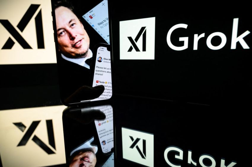 This photograph taken on Jan. 13, 2025, in Toulouse shows screens displaying the logo of Grok, a generative artificial intelligence chatbot developed by xAI, the American company specializing in artificial intelligence and its founder South African businessman Elon Musk. 