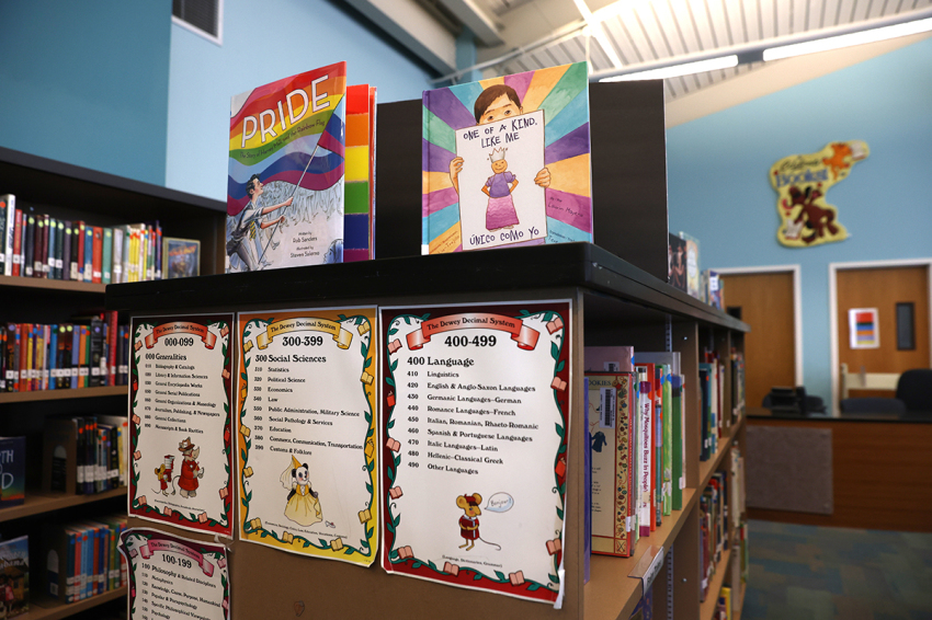 Newly donated LGBTQ+ books are displayed in the library