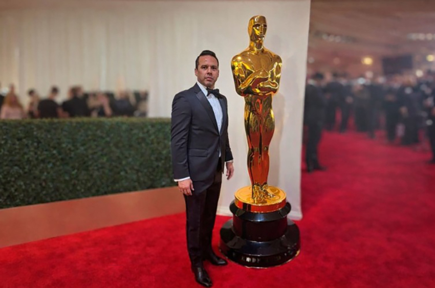 The Rev. Samuel Rodriguez poses next to the Academy Award statue during the red carpet in Los Angeles, California. 