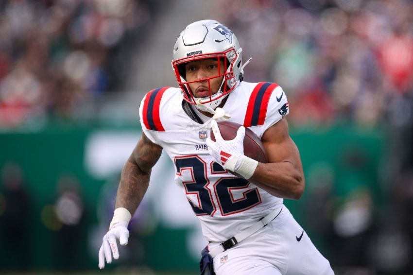 TreVeyon Henderson of the New England Patriots runs with the ball against the New York Jets during the first quarter at MetLife Stadium on December 28, 2025, in East Rutherford, New Jersey.