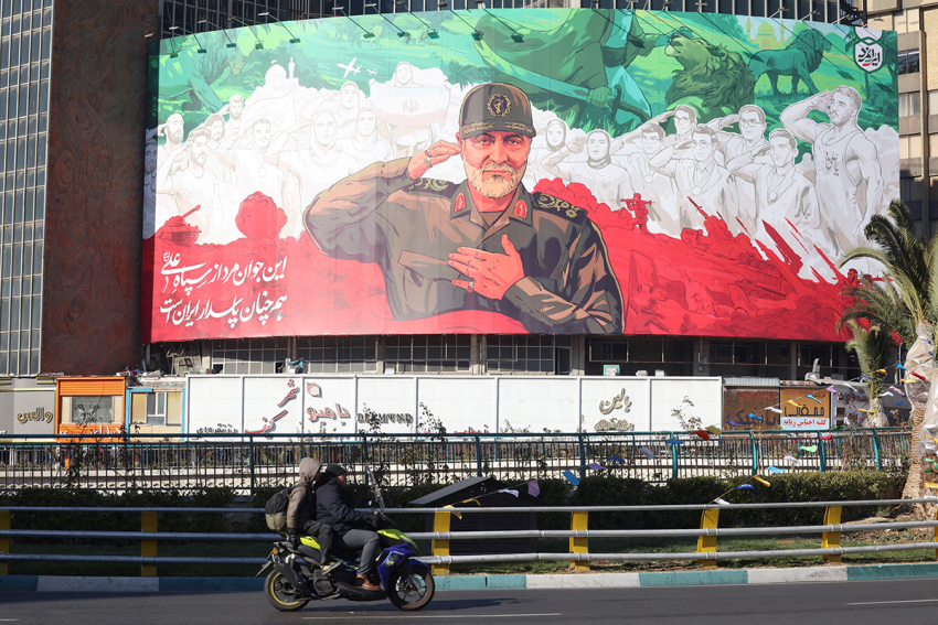 Iranians ride their motorbike past a huge banner of former Iran Islamic Revolutionary Guard Corps (IRGC) Quds Force commander Qasem Soleimani ahead of the sixth anniversary of his assassination. Photo taken at Valiasr Square in Tehran, on Dec. 31, 2025. Soleimani was killed on Jan. 3, 2020, in a targeted U.S. airstrike at Baghdad airport in Iraq. 