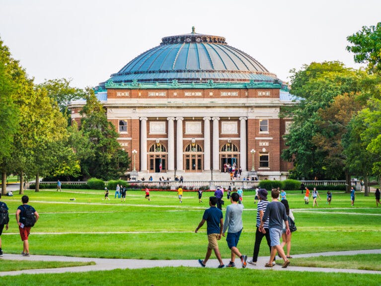 Urbana, Illinois, April 17, 2016 - Students walk and socialize on the Quad lawn of the University of Illinois college campus in Urbana Champaign. leightrail. Getty Images.