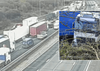 Drivers face long delays as lorry crashes into power line causing 'exposed wires' and electric failures