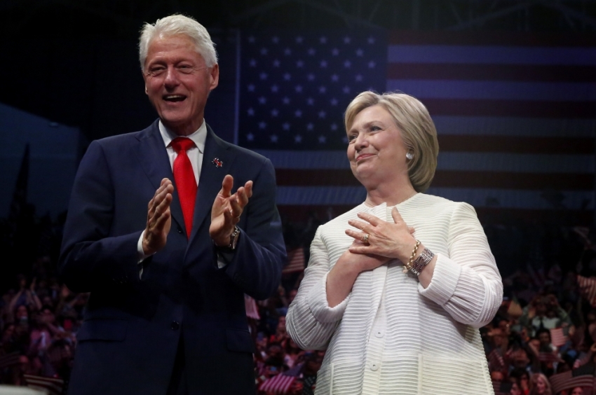Democratic presidential candidate Hillary Clinton stands onstage with former President Bill Clinton after speaking during her California primary night rally held in the Brooklyn borough of New York, on June 7, 2016.