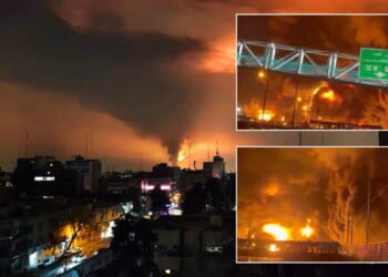 Iranians warned of acid rain after massive fuel depot fire as 'oil falls from sky'