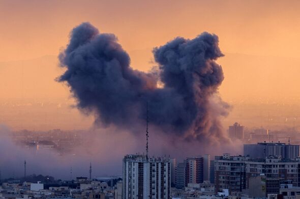 TOPSHOT - A plume of smoke rises after a strike on the Iranian capital Tehran, on March 3, 2026. Iran stepped up its attacks on 