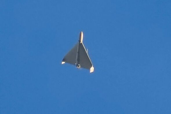 FILE - An Iranian Shahed exploding drone launched by Russia flies through the sky seconds before it struck buildings in Kyiv, Uk