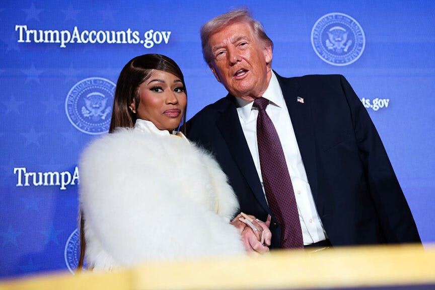WASHINGTON, DC - JANUARY 28: Musician Nicki Minaj (L) joins U.S. President Donald Trump on stage as he delivers remarks during the Treasury Department's Trump Accounts Summit at Andrew W. Mellon Auditorium on January 28, 2026 in Washington, DC. "Trump Accounts" are a portion of recently passed tax and spending legislation where the federal government will deposit $1,000 into investment accounts for every child born between 2025 and 2028 once parents sign their children up while filing their income taxes.  (Photo by Win McNamee/Getty Images)