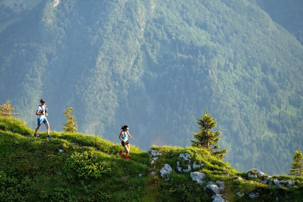 Couple Enjoying Scenic Run on Mountain Path