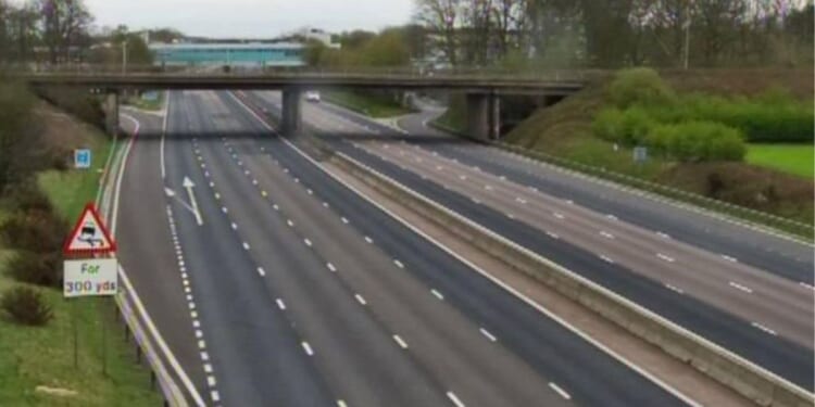 Major motorway shut as emergency services 'rescue driver and vehicle from water'