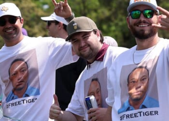 Golf fans seen wearing shirts of Tiger Woods mugshot during tournament after legend's arrest