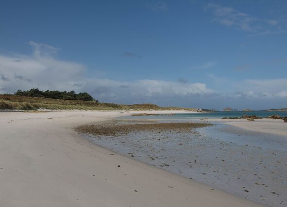 Panoramic Landscape on the Derseted Pentle Beach with a Dramatic Cloudy Blue Sky Background on the Island of Tresco in the Isles of Scilly, England, U