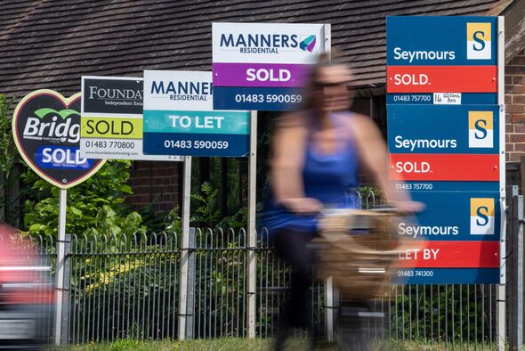 Estate agents 'Sold' and 'Let' signs outside residential properties in Woking, UK, on Monday, July 28, 2025. The number of UK ho