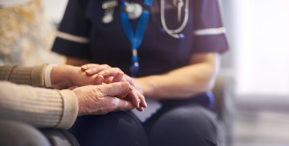 Nurse comforting patient at patient's home