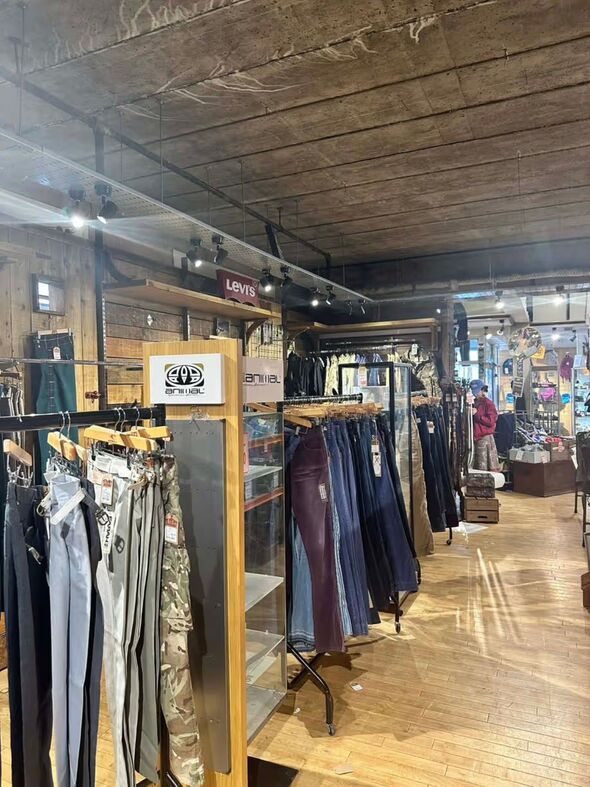 Jeans and trousers hung up inside a clothing store Jeans and trousers hung up inside a clothing store