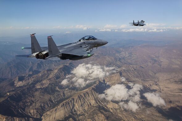 F-15 Fighter Jets flying over mountains F-15 Fighter Jets flying over mountains