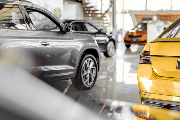 shiny new cars inside a car dealership